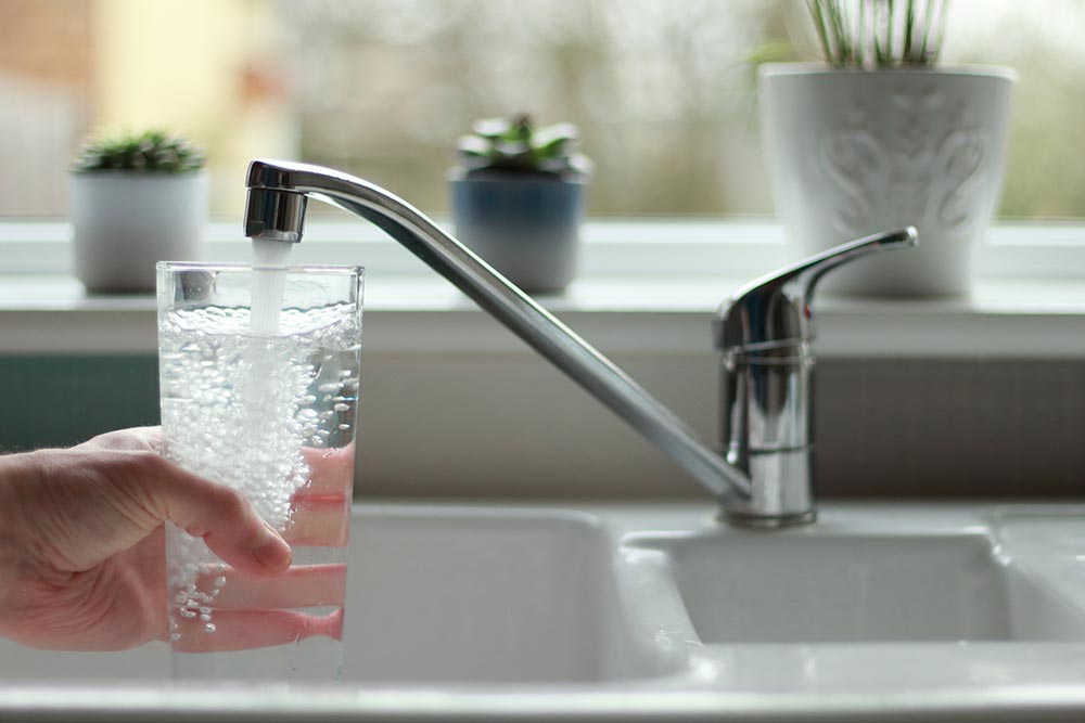 Glass filling up with water | Water treatment services by Heating Repair in Warwick, MD | A.L. Boulden & Son, Inc. in Warwick, MD